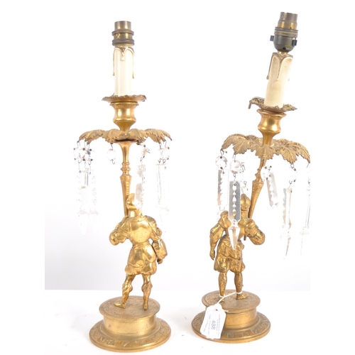 488 - A pair of early 19th Century Regency period bronze ormolu candlesticks in the form of soldiers holdi... 