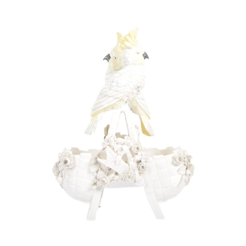 490 - A 19th Century Continental porcelain figurine group depicting a pair of cockatoos mounted on twin wo... 