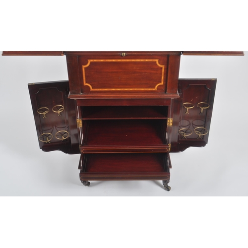 50 - An early 20th Century Edwardian mahogany inlaid drinks bar entitled The Eclipse. Twin folding doors ... 