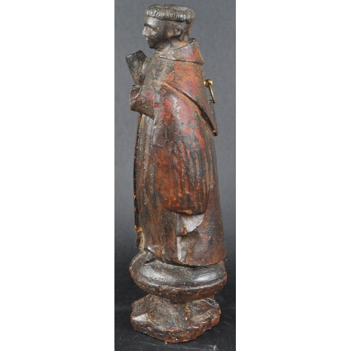 503 - A 19th possibly 18th century walnut carving of a monk. Figure posed as standing on an orb with both ... 