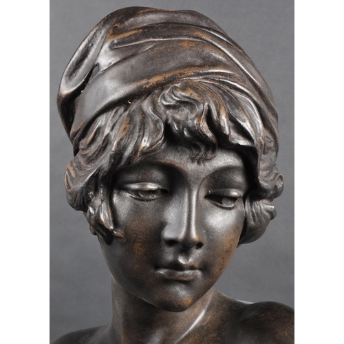 507 - A faux bronze statue bust study in the form of a young woman. Modelled with hair in cloth and detail... 