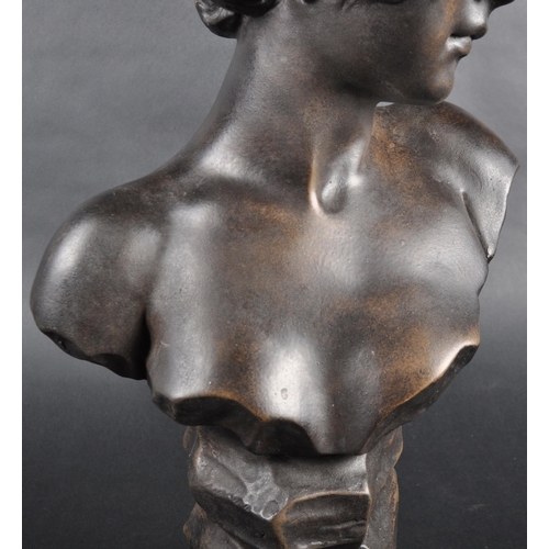 507 - A faux bronze statue bust study in the form of a young woman. Modelled with hair in cloth and detail... 