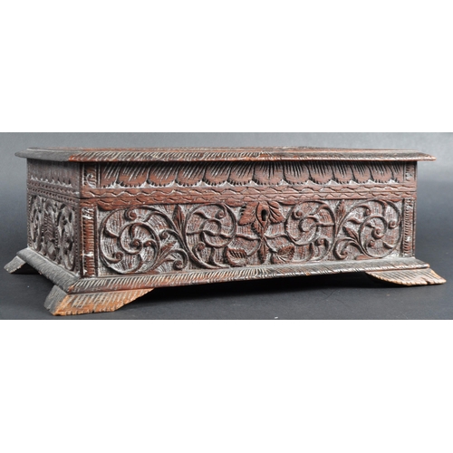 511 - A 19th Century carved Anglo-Indian colonial workbox / jewellery box. Carved scrolling leaves and rep... 