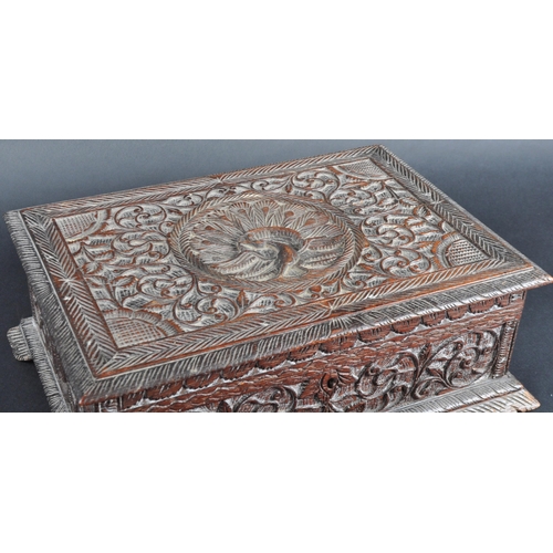 511 - A 19th Century carved Anglo-Indian colonial workbox / jewellery box. Carved scrolling leaves and rep... 