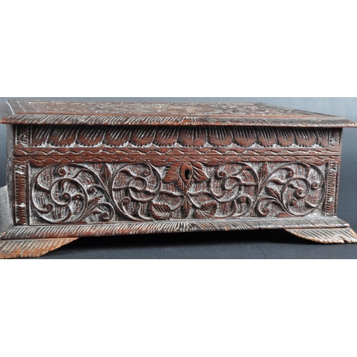 511 - A 19th Century carved Anglo-Indian colonial workbox / jewellery box. Carved scrolling leaves and rep... 