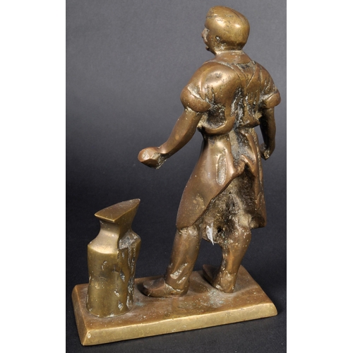 513 - A 19th Century Victorian bronze figurine. The figure depicting a blacksmith standing by anvil with s... 