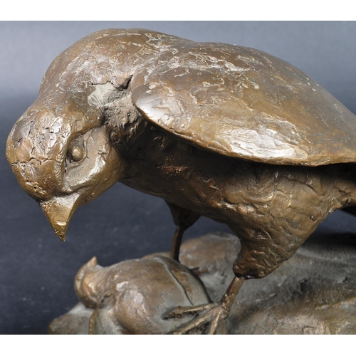 515 - A 20th Century bronze statue figure depicting a Falcon stood triumphant upon his prey raised on a na... 