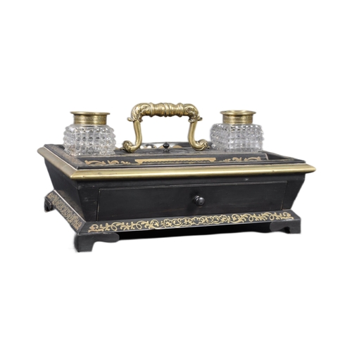 517 - A 19th Century Regency ebonised and Boulle work desk stand / tidy having a leaf work brass handle wi... 