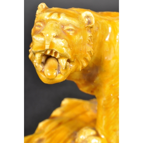 525 - A pair of 19th Century Victorian glazed ceramic tigers with each in a prowling position with mouths ... 