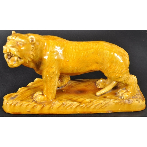 525 - A pair of 19th Century Victorian glazed ceramic tigers with each in a prowling position with mouths ... 