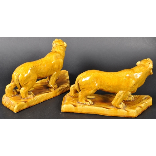 525 - A pair of 19th Century Victorian glazed ceramic tigers with each in a prowling position with mouths ... 