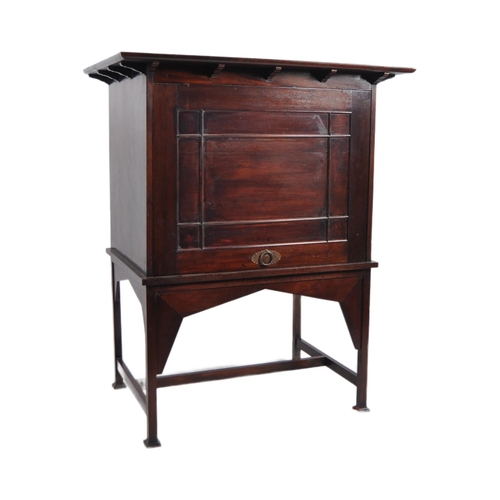 54 - Manner of E A Taylors for Wylie and Lochhead - A 20th Century Mahogany Arts & Crafts cabinet on stan... 