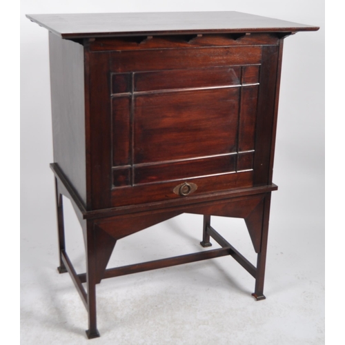 54 - Manner of E A Taylors for Wylie and Lochhead - A 20th Century Mahogany Arts & Crafts cabinet on stan... 