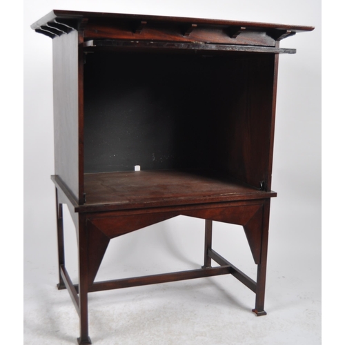 54 - Manner of E A Taylors for Wylie and Lochhead - A 20th Century Mahogany Arts & Crafts cabinet on stan... 