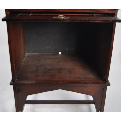 54 - Manner of E A Taylors for Wylie and Lochhead - A 20th Century Mahogany Arts & Crafts cabinet on stan... 