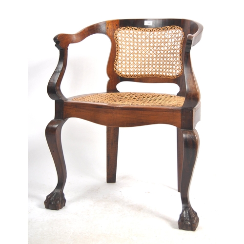 540 - A 19th Century mahogany captains chair / desk armchair having a shaped backrest & arms with bergere ... 