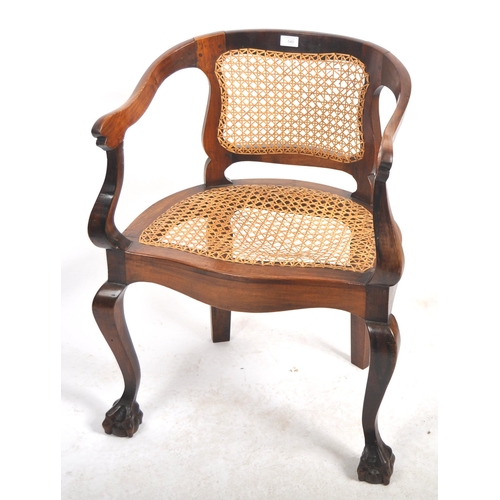 540 - A 19th Century mahogany captains chair / desk armchair having a shaped backrest & arms with bergere ... 