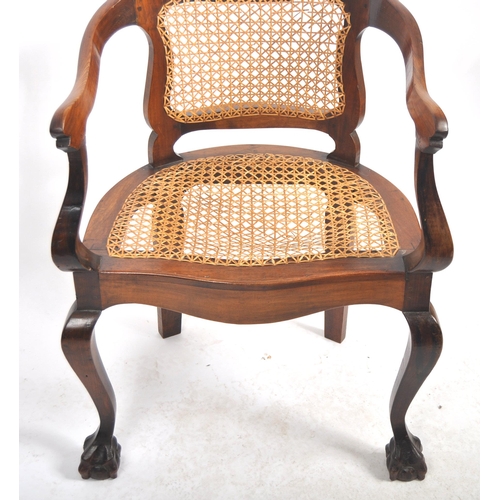 540 - A 19th Century mahogany captains chair / desk armchair having a shaped backrest & arms with bergere ... 