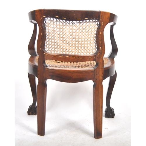 540 - A 19th Century mahogany captains chair / desk armchair having a shaped backrest & arms with bergere ... 