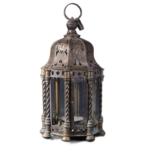 551 - A late 19th Century brass worked hanging lantern having a large hanging hoop atop with embossed face... 