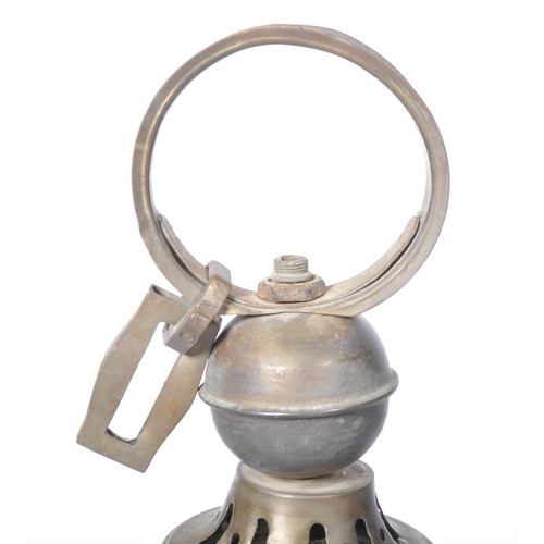 551 - A late 19th Century brass worked hanging lantern having a large hanging hoop atop with embossed face... 