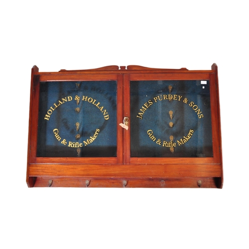 552 - An early 20th century mahogany gunsmiths shooting gun stock cabinet. Twin glazed door with notation ... 