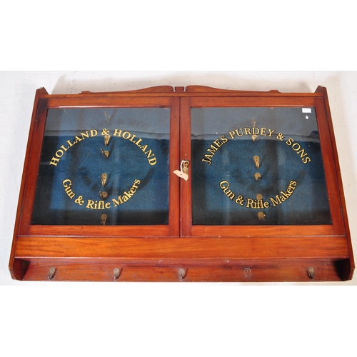 552 - An early 20th century mahogany gunsmiths shooting gun stock cabinet. Twin glazed door with notation ... 