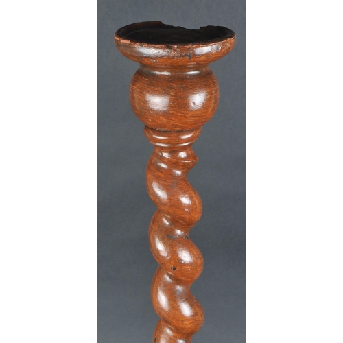 557 - A 19th century English oak barley twist church altar candlestick holder.  The tall barley twist shap... 