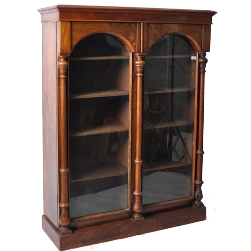 56 - A 19th Century Victorian walnut library bookcase cabinet vitrine. Flared pediment top with twin glaz... 