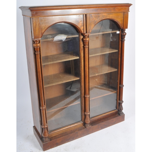 56 - A 19th Century Victorian walnut library bookcase cabinet vitrine. Flared pediment top with twin glaz... 