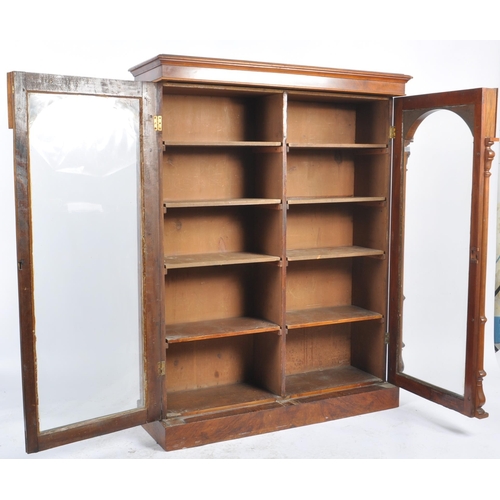 56 - A 19th Century Victorian walnut library bookcase cabinet vitrine. Flared pediment top with twin glaz... 