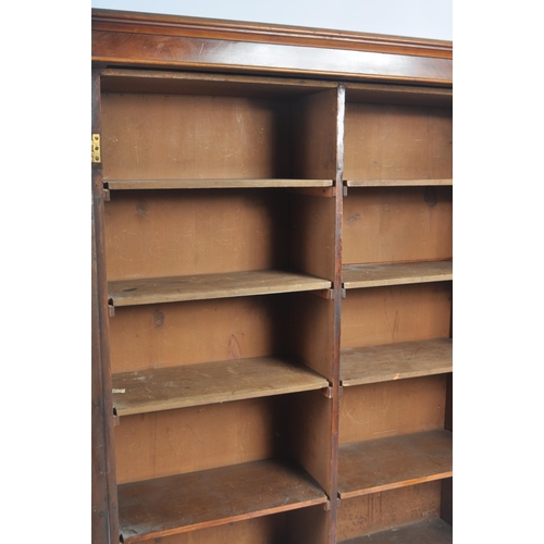 56 - A 19th Century Victorian walnut library bookcase cabinet vitrine. Flared pediment top with twin glaz... 