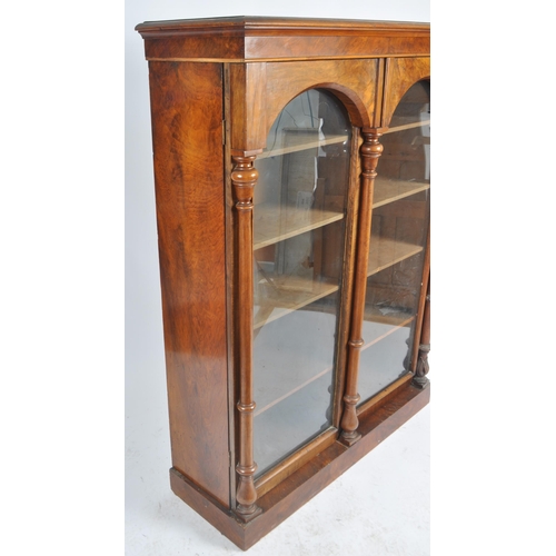 56 - A 19th Century Victorian walnut library bookcase cabinet vitrine. Flared pediment top with twin glaz... 