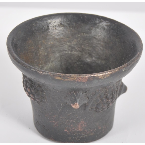 573 - A 17th century bronze miniature poison mortar. Of frustoconical form decorated on the outside with r... 