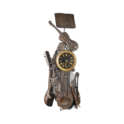 575 - A 19th Century French Aubert of Paris bronze worked music clock in the form a lectern adorned with m... 