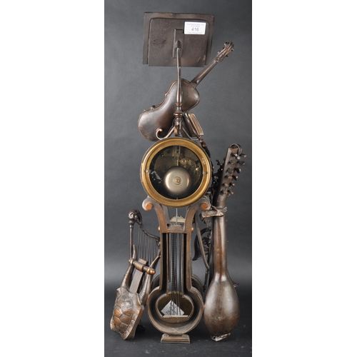 575 - A 19th Century French Aubert of Paris bronze worked music clock in the form a lectern adorned with m... 