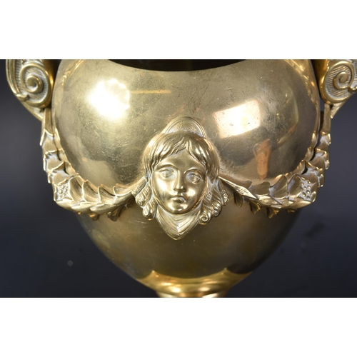 577 - A 19th Century Victorian brass urn of classical form. Ovoid body with twin wings to side and cast an... 