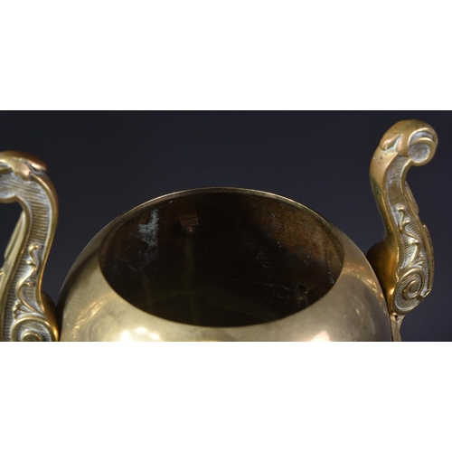 577 - A 19th Century Victorian brass urn of classical form. Ovoid body with twin wings to side and cast an... 