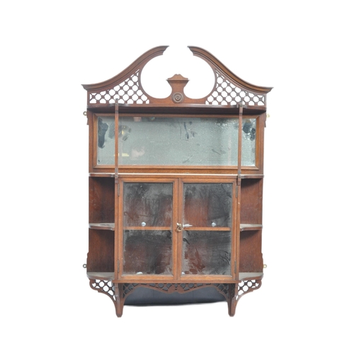 578 - A 19th Century Victorian mahogany having display cabinet having a fret pierced arched top with mirro... 