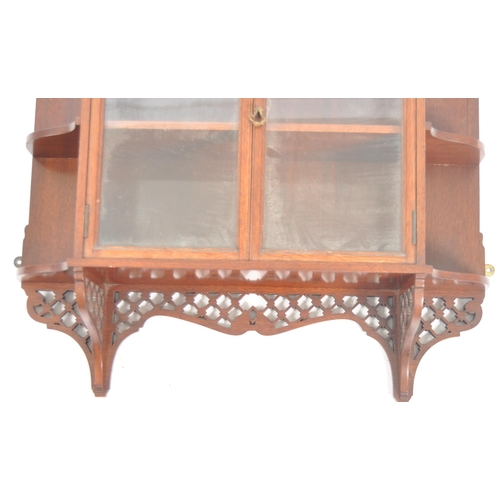 578 - A 19th Century Victorian mahogany having display cabinet having a fret pierced arched top with mirro... 