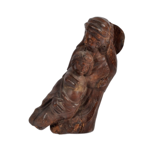 579 - A 20th century oak carving of mother and child.  Carved from a single piece, believed to represent t... 