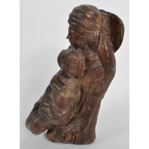 579 - A 20th century oak carving of mother and child.  Carved from a single piece, believed to represent t... 