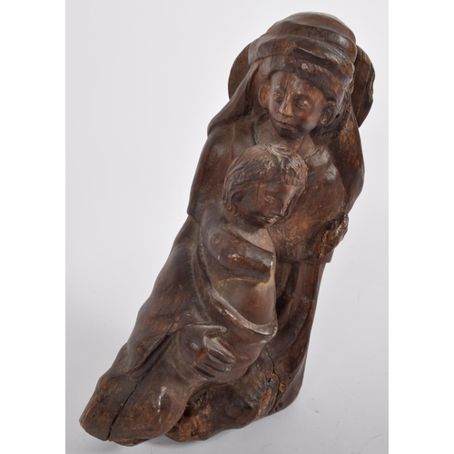 579 - A 20th century oak carving of mother and child.  Carved from a single piece, believed to represent t... 