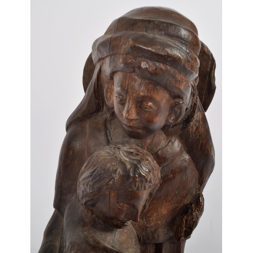 579 - A 20th century oak carving of mother and child.  Carved from a single piece, believed to represent t... 