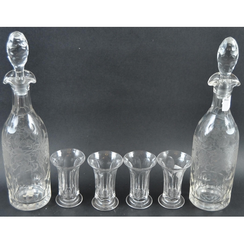 614 - A 19th Century etched glass liquor drinks set comprising of two tall decanters with faceted stoppers... 