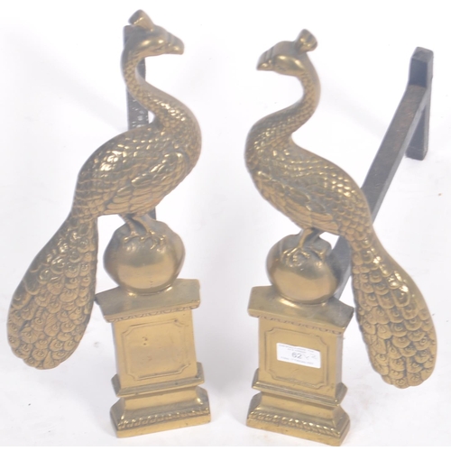 62 - A pair of 19th Century Victorian brass fireside peacocks. Ornate with cast features set to cast blac... 