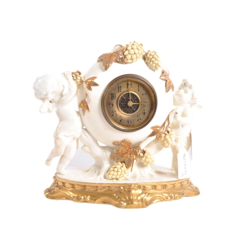 626 - A late 19th century porcelain mantel clock, decorated with cherubs eating grapes on a gilded base. T... 