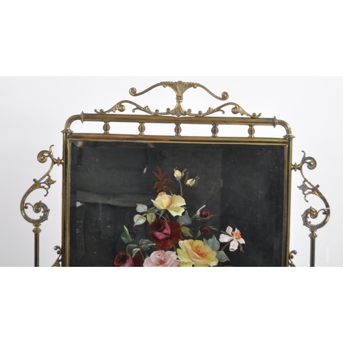 634 - A 19th Century Victorian brass fire screen. Ornate form with scrollwork frame and central glass mirr... 