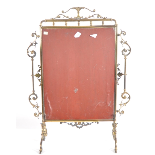 634 - A 19th Century Victorian brass fire screen. Ornate form with scrollwork frame and central glass mirr... 