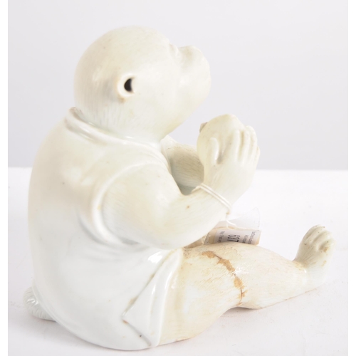 637 - A 19th Century Hirado (Japanese) porcelain monkey, late 19th Century, white glazed, modelled seated ... 